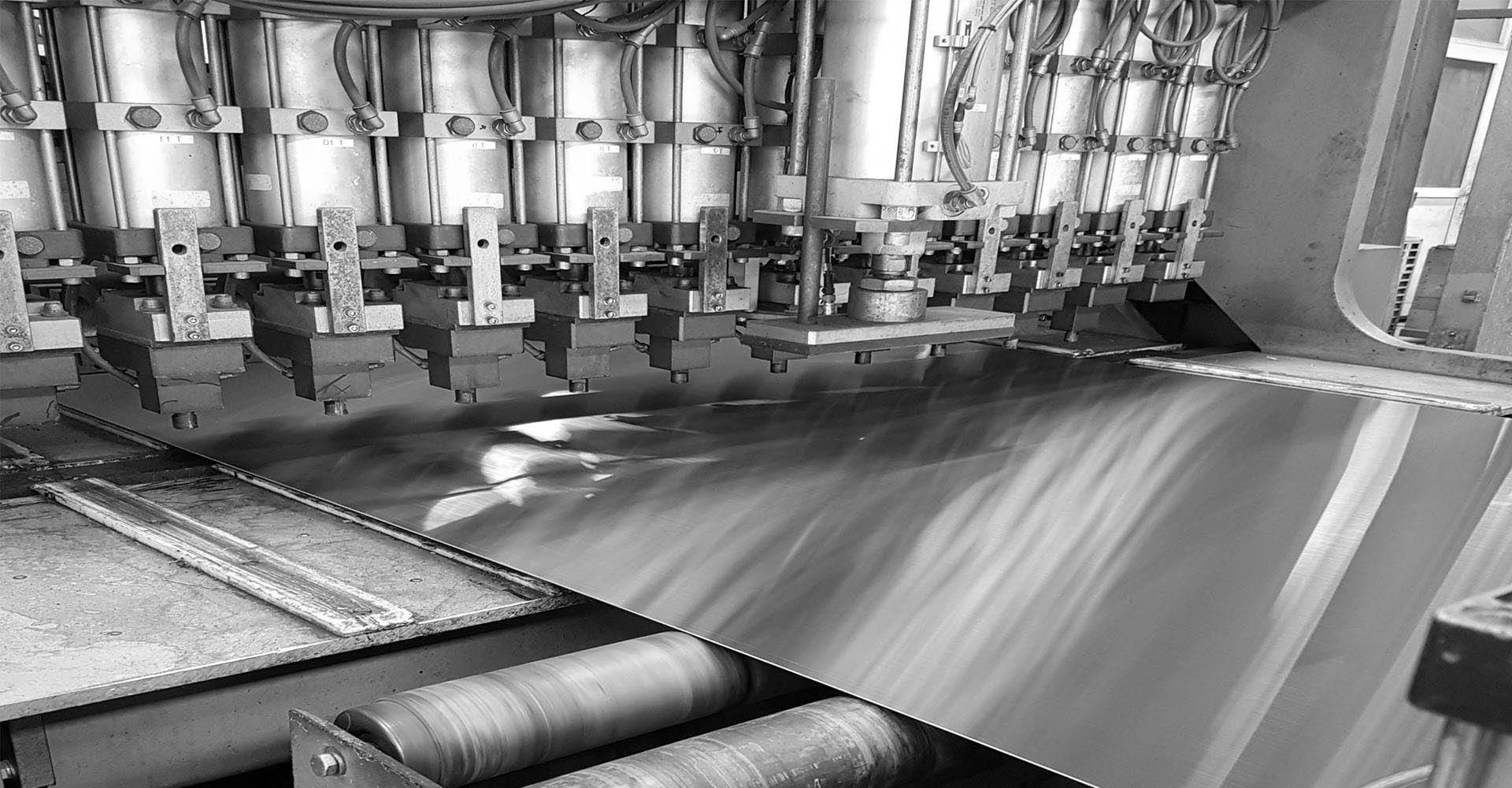 A machine in a factory producing metal sheets